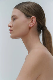 Silver earrings, featuring a structured band and a bold amber element.
