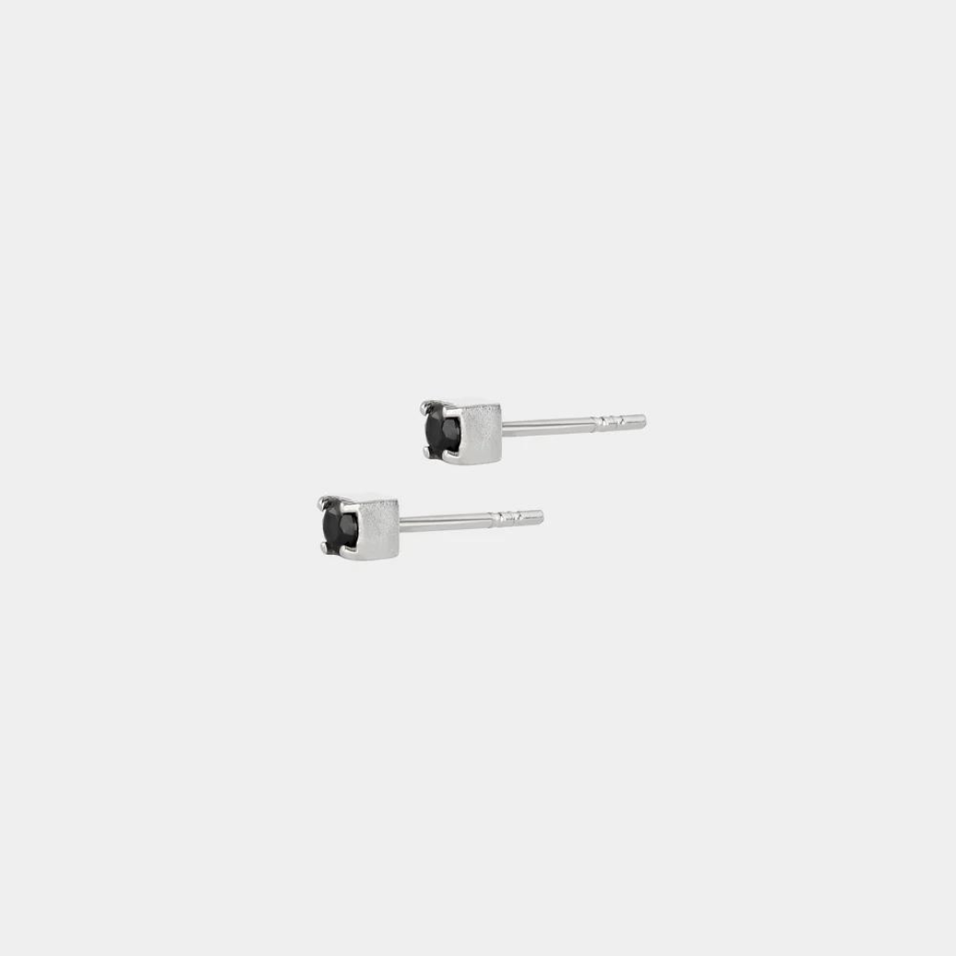 A pair of silver earrings with black zirconium, featuring a geometric pattern.