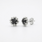 Pair of silver earrings with black diamonds on a white background