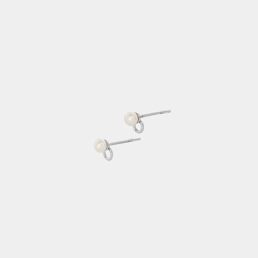 A pair of silver earrings featuring a round pearl connected by a silver dot, presented on a white background.