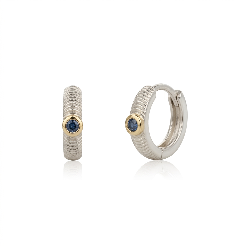 Pair of hoop earrings with blue sapphires on a white background