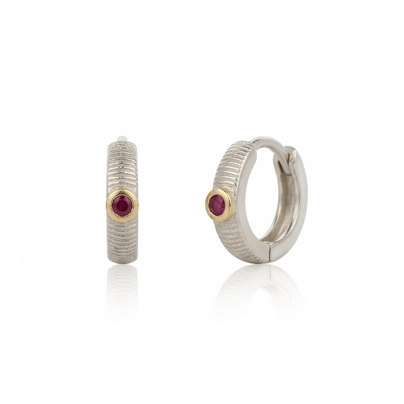 Pair of hoop earrings with rubies on a white background