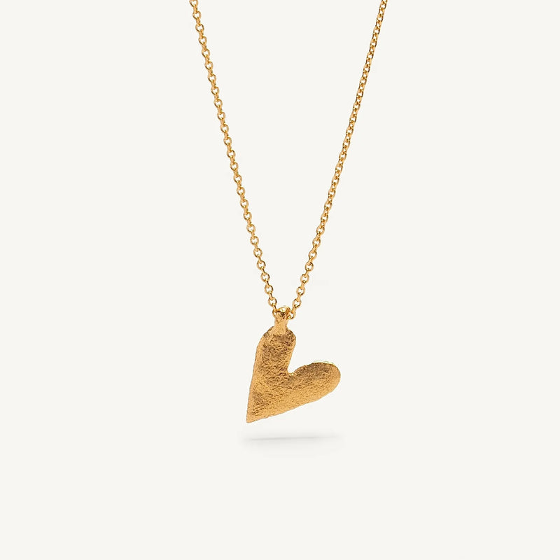 Gold heart-shaped pendant necklace on a white background