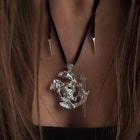 One-of-a-kind necklace featuring a unique water-cast sterling silver pendant with an organic, sculptural form and delicate linear drops. 
