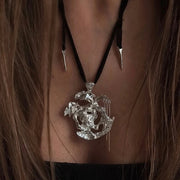 One-of-a-kind necklace featuring a unique water-cast sterling silver pendant with an organic, sculptural form and delicate linear drops. 