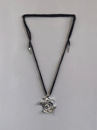 One-of-a-kind necklace featuring a unique water-cast sterling silver pendant with an organic, sculptural form and delicate linear drops. 