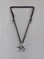 One-of-a-kind necklace featuring a unique water-cast sterling silver pendant with an organic, sculptural form and delicate linear drops. 