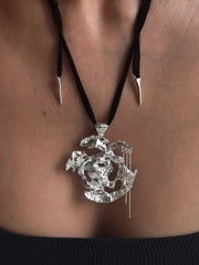One-of-a-kind necklace featuring a unique water-cast sterling silver pendant with an organic, sculptural form and delicate linear drops. 