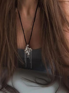 One-of-a-kind necklace featuring a unique water-cast sterling silver pendant with an organic, sculptural form and delicate linear drops.