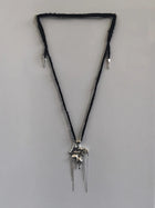 One-of-a-kind necklace featuring a unique water-cast sterling silver pendant with an organic, sculptural form and delicate linear drops.