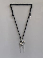 One-of-a-kind necklace featuring a unique water-cast sterling silver pendant with an organic, sculptural form and delicate linear drops.