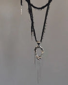 One-of-a-kind necklace featuring a unique water-cast sterling silver pendant with an organic, sculptural form and delicate linear drops. 