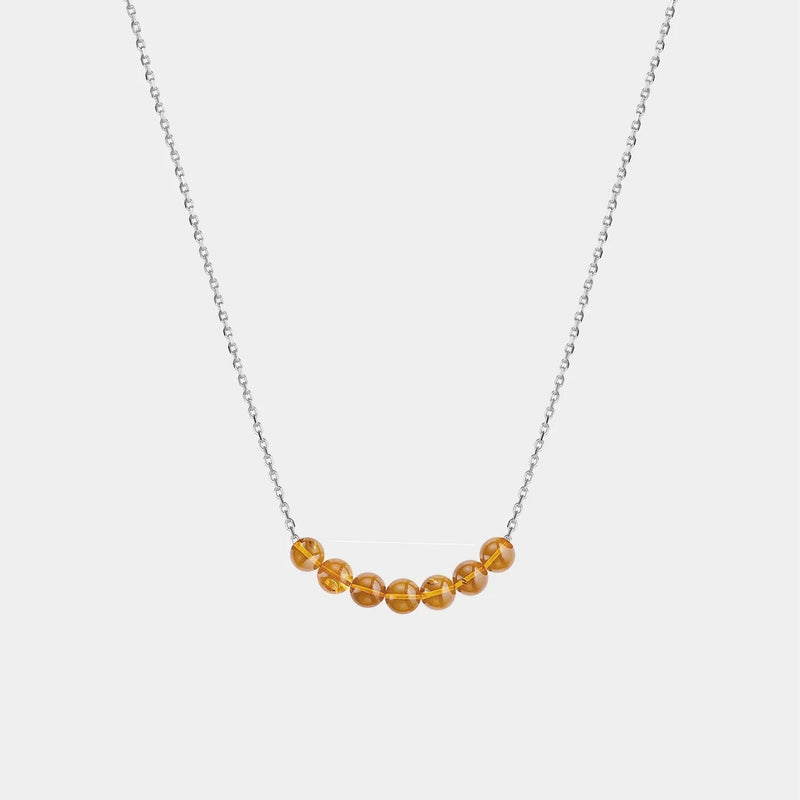 Necklace with Baltic amber beads on a white background