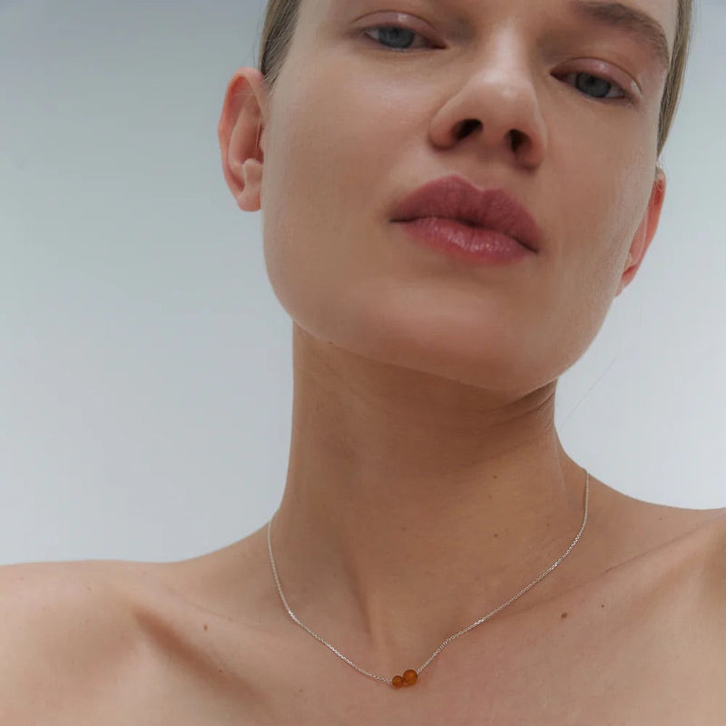 Gold necklace with two asymmetrical Baltic amber pendants by Adele Notes. 