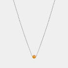 Silver necklace with small Baltic amber pendant by Adele Notes. 