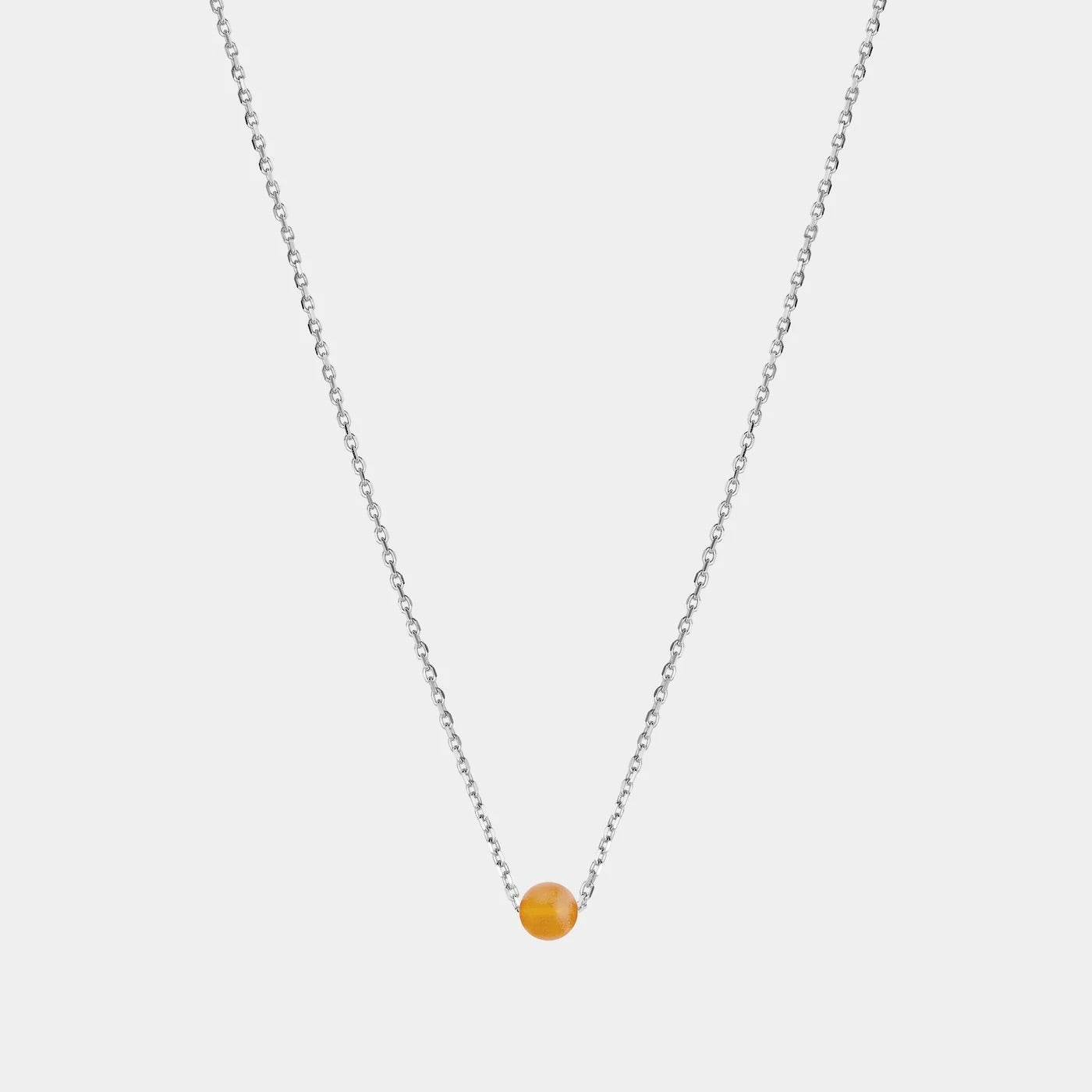 Silver necklace with small Baltic amber pendant by Adele Notes. 