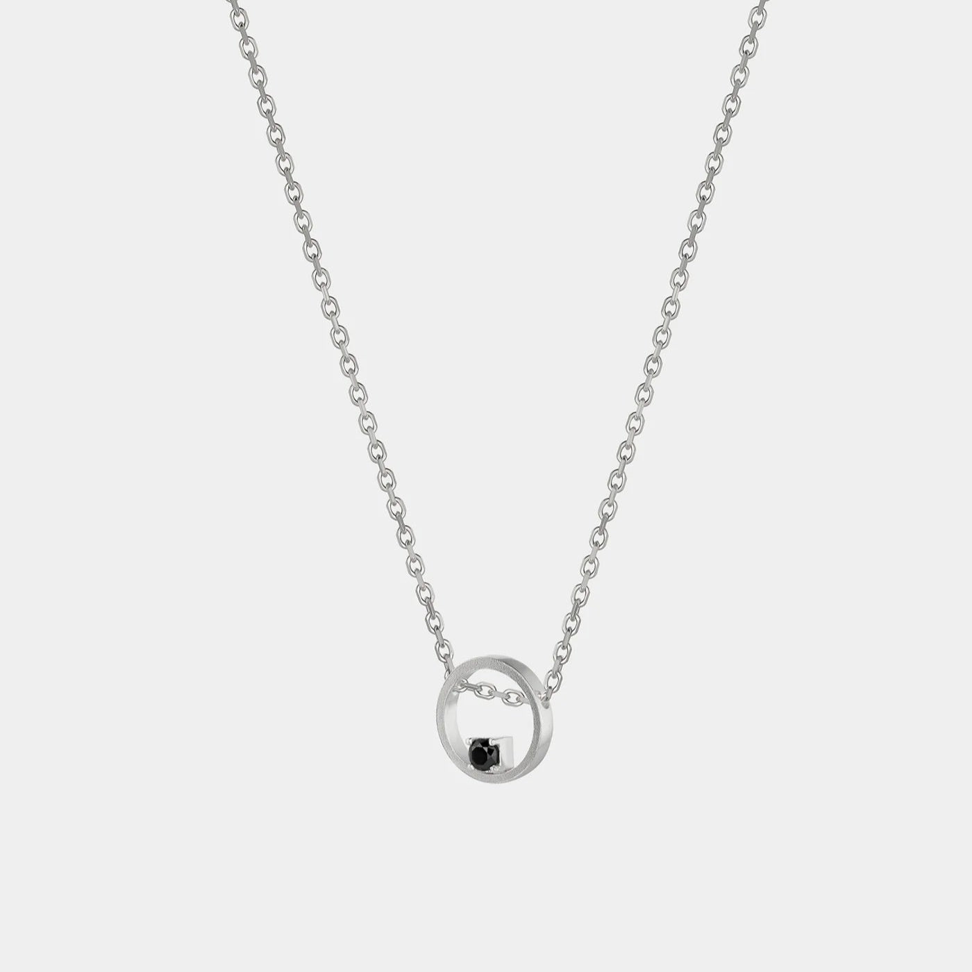 Silver necklace with a black zirconium pendant on a white background