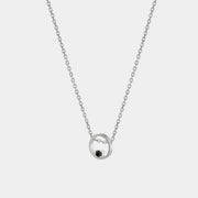 Silver necklace with a black zirconium pendant on a white background