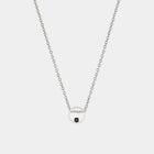 Silver necklace with a small round pendant on a light gray background