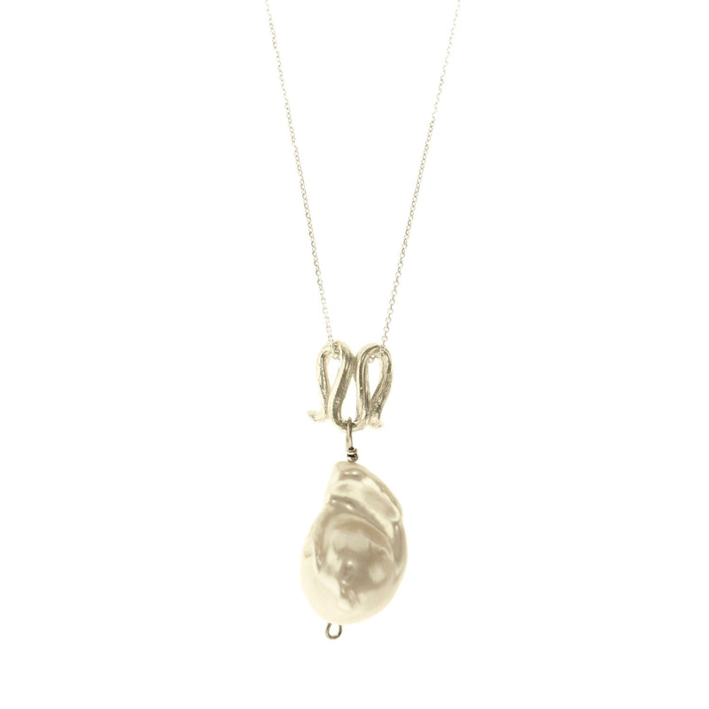 Infinity-shaped pendant featuring baroque shaped freshwater pearl. 