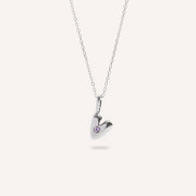 Heart-shaped silver pendant with a small gemstone on a white background