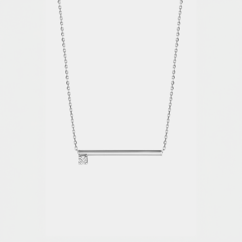 Silver necklace with a zirconium  pendant on a light gray background