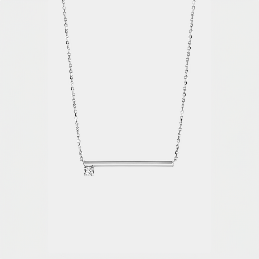 Silver necklace with a zirconium  pendant on a light gray background