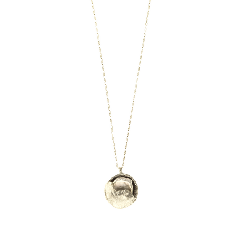 A silver necklace with a half moon nurturing pearl design, featuring a gold-plated chain and a freshwater pearl pendant.