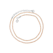 Freshwater pearl necklace with a silver chain extender displayed on a clean white background.
