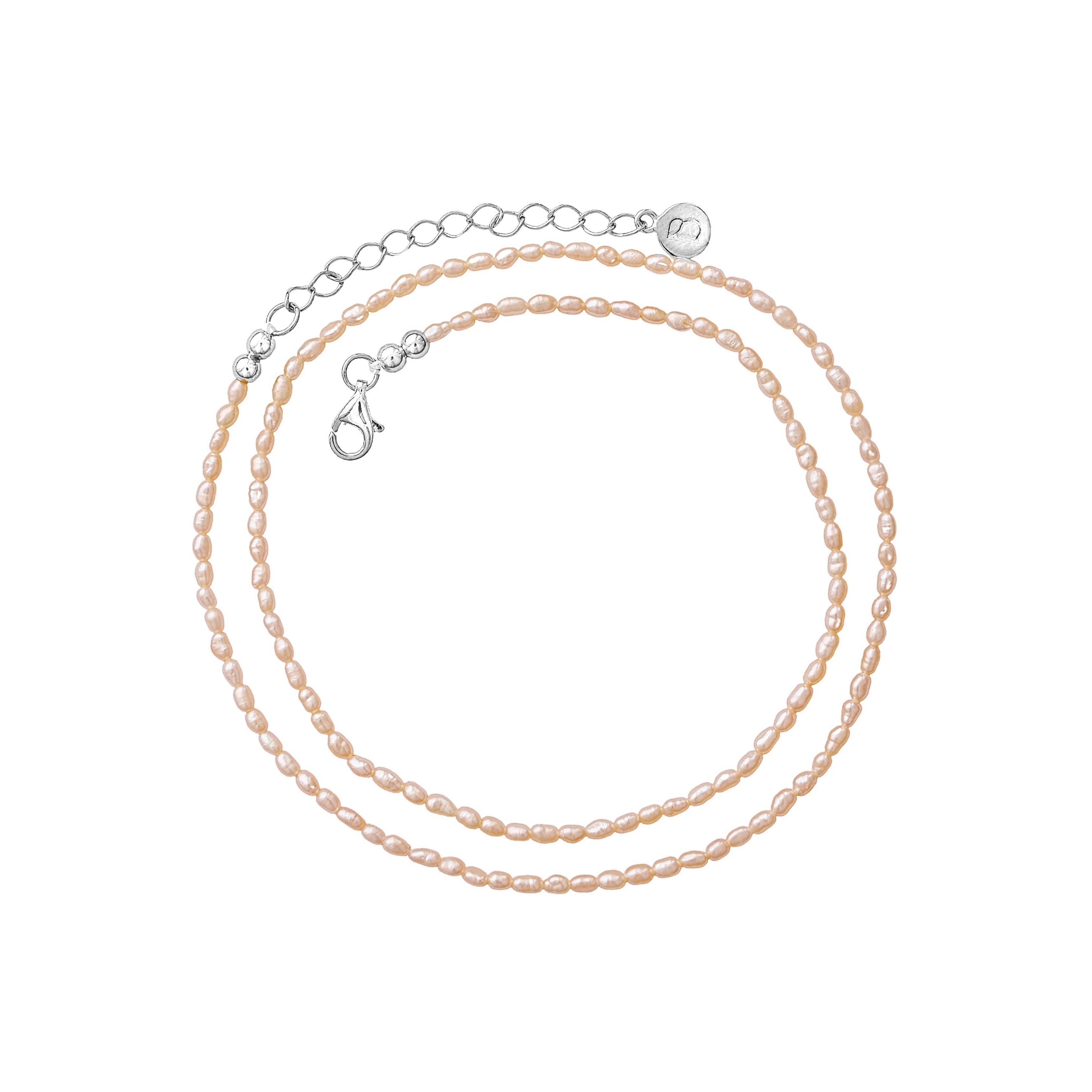 Freshwater pearl necklace with a silver chain extender displayed on a clean white background.