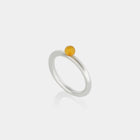 Silver ring with a Baltic amber on a white background