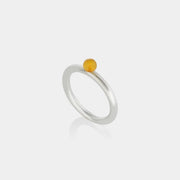 Silver ring with a Baltic amber on a white background