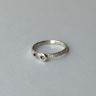 A silver ring with blue sapphires set in it, presented on a white background.