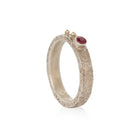 Silver ring with a orange sapphire on a white background