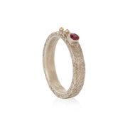 Silver ring with a orange sapphire on a white background