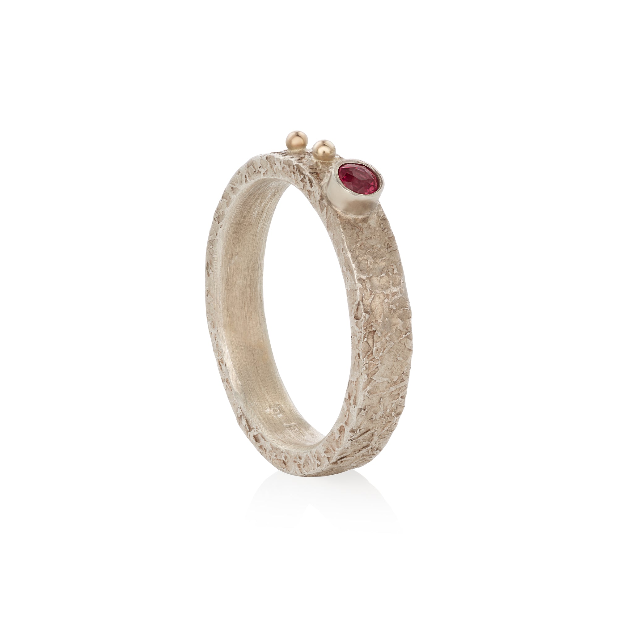 Silver ring with a orange sapphire on a white background