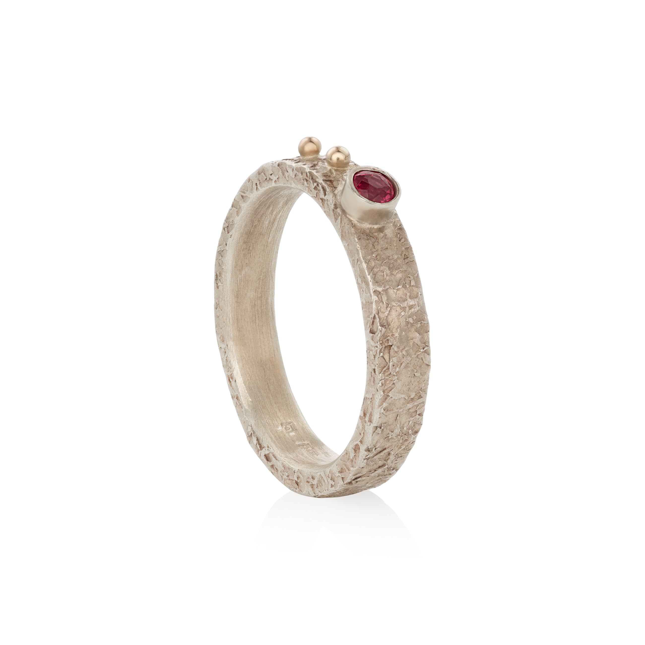Silver ring with a orange sapphire on a white background