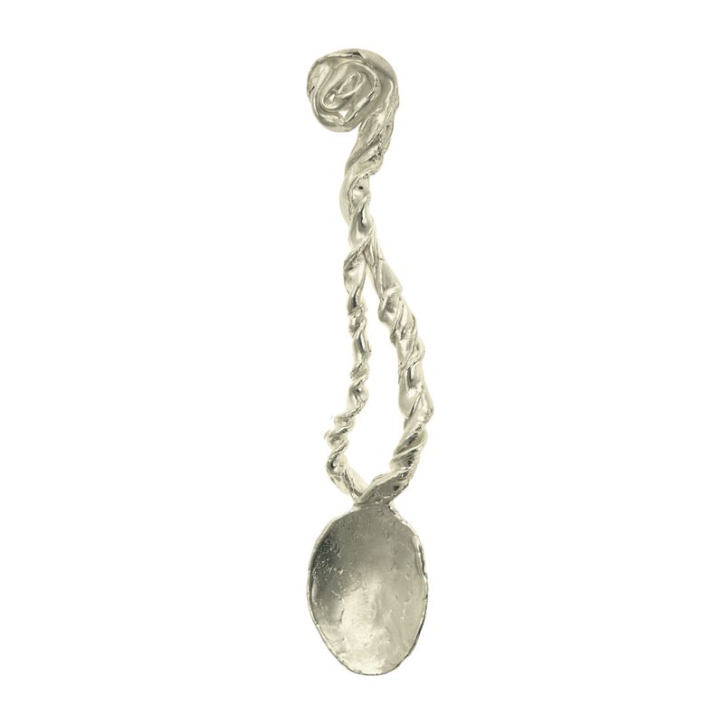 A handcrafted, silver spoon with a twisted design, evoking a sense of ancient magic and myth.