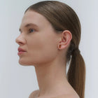 Silver stud earrings, featuring Baltic amber by Adele Notes.