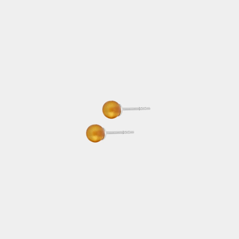 Silver stud earrings, featuring Baltic amber by Adele Notes.