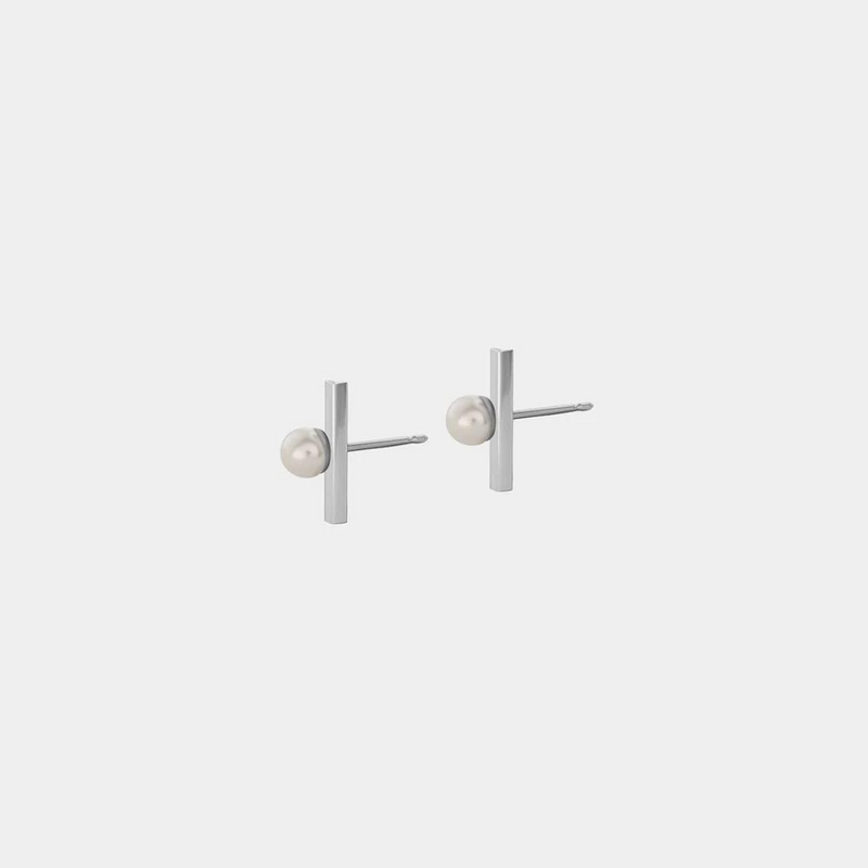 A pair of silver stud earrings with a round pearl attached to silver string, against a white background.