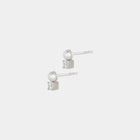 Pair of silver earrings with freshwater pearls and white zirconium stones on a light gray background
