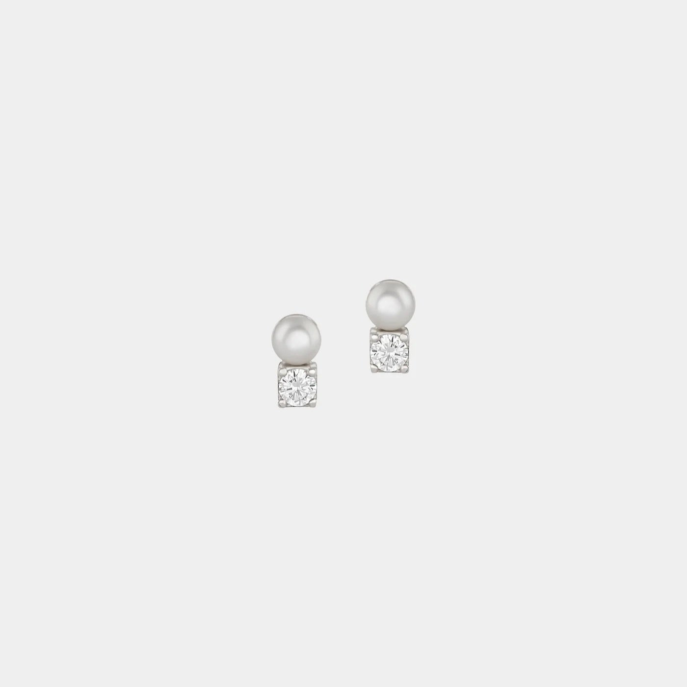 Pair of pearl earrings on a light gray background