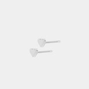 Silver heart-shaped earrigns on a white background