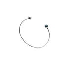 A delicate gold open cuff bracelet with a small dark blue faceted diamonds set in each end, shown on a plain white background.