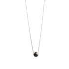 A delicate gold necklace with a faceted diamond pendant, displayed on a clean white background.