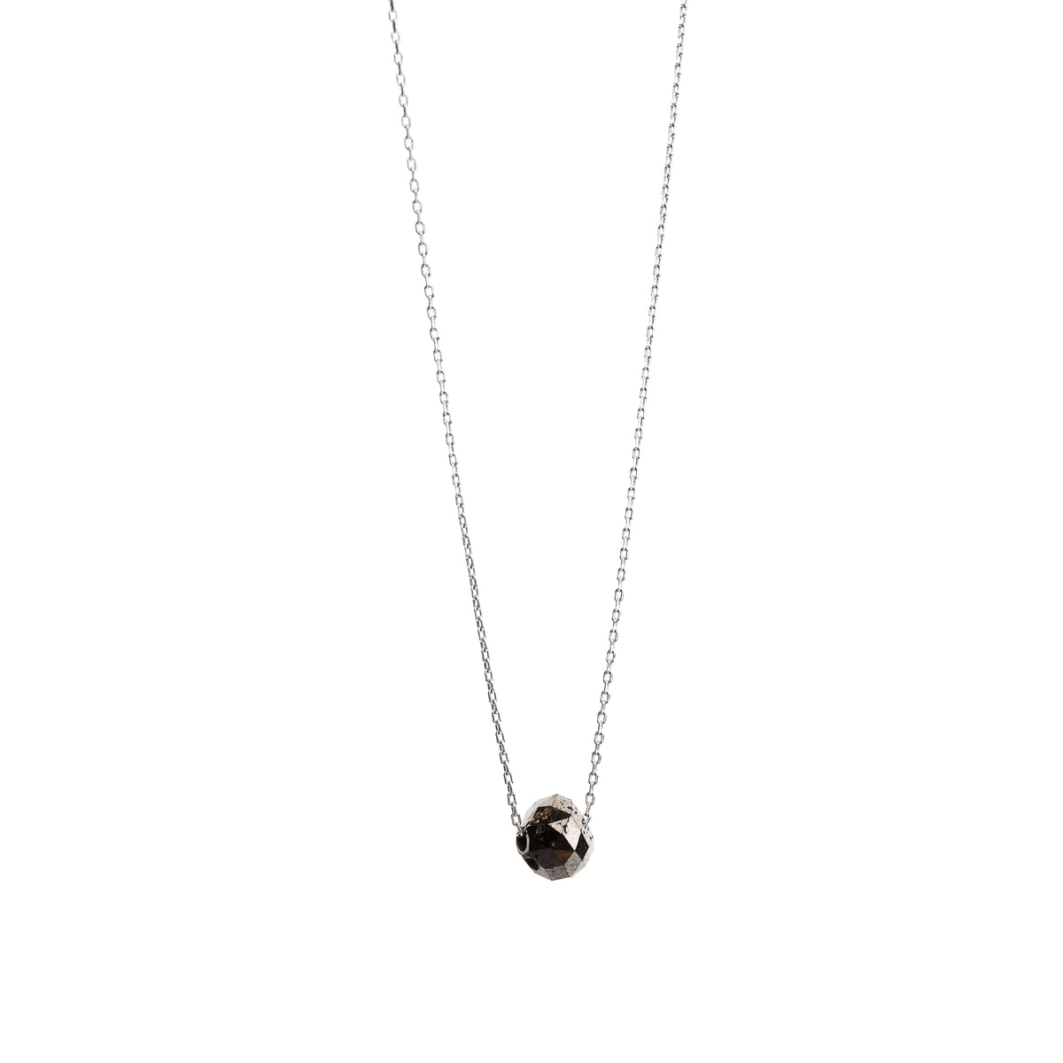 A delicate gold necklace with a faceted diamond pendant, displayed on a clean white background.