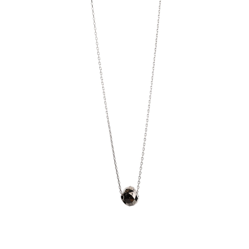 A delicate gold necklace with a faceted diamond pendant, displayed on a clean white background.