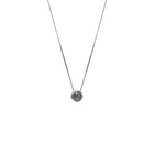 A delicate gold chain necklace with a small bezel-set rose-cut grey diamond pendant, shown against a plain white background.