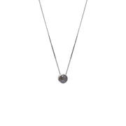 A delicate gold chain necklace with a small bezel-set rose-cut grey diamond pendant, shown against a plain white background.